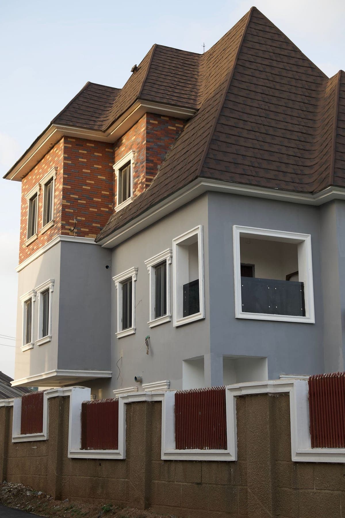 Modern detached duplex with a pitched roof and brick façade detailing